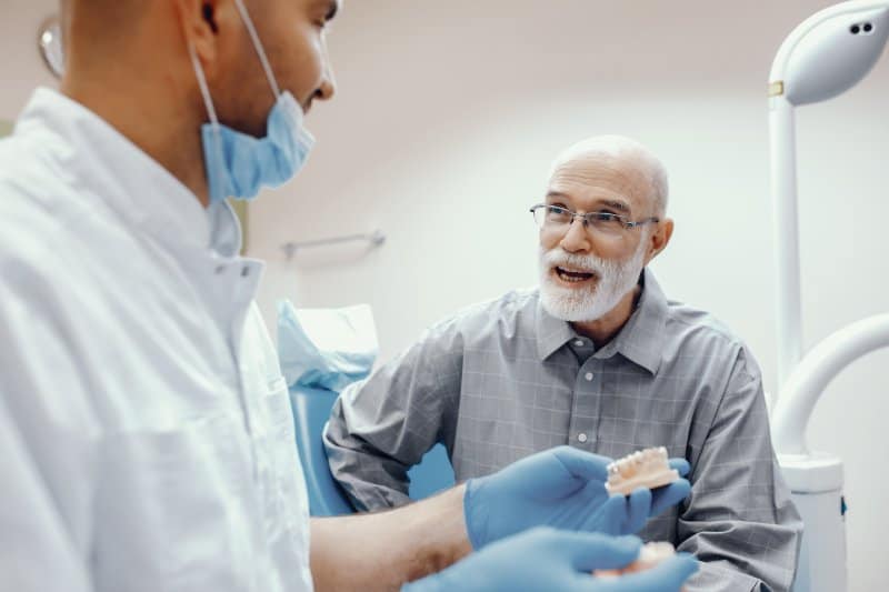 man learning about transition from dentures to dental implants