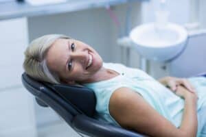 mature woman smiling in dental chair