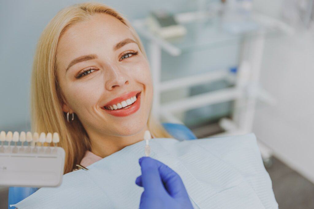 Woman with blonde hair smiling in dentist's treatment chair